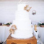 White wedding cake with burlap bows
