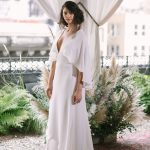 Sleek white wedding dress with low cut neckline Alexandra Grecco