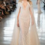 Blush pink ethereal wedding dress with embroideries and a cape Berta