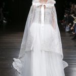 Ball gown wedding dress with a sheer cape and a big bow Naeem Khan