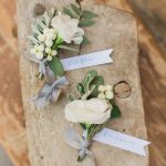 Groom and best man's boutonniere with roses and olive leaves